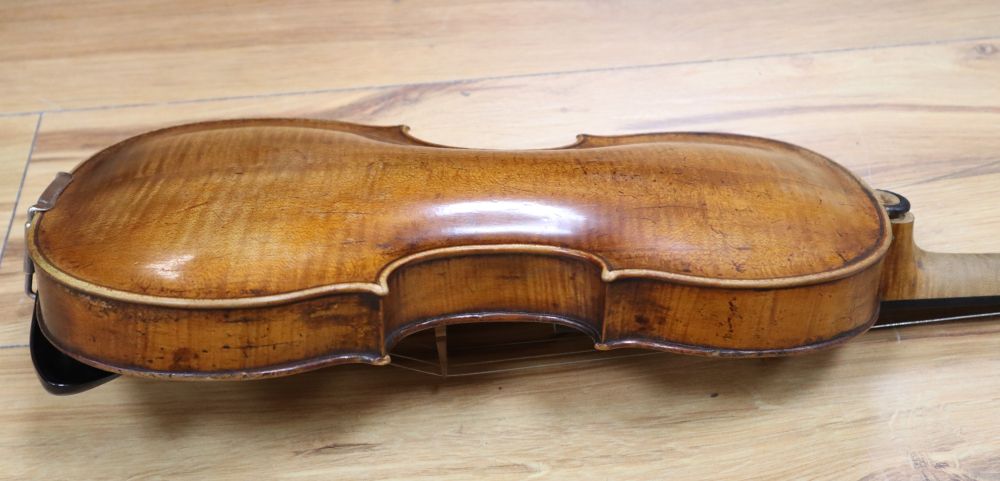 A cased violin with two bows. Violin bears the label Carl Willhelm Claesel, circa late 18th century/early 19th century, 35.5cm back in